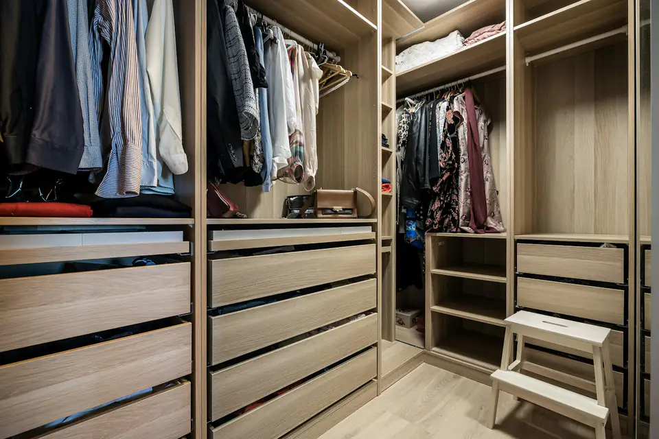 Oak walk-in wardrobe with drawers | Fitted wardrobes Newcastle Oak-effect walk-in wardrobe with long drawer runs and hanging rails, a storage idea for homes in Newcastle